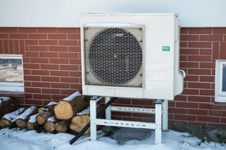 heat pump covered in snow