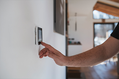 Man adjusting thermostat
